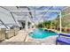 Large pool with covered patio, dining area, and lounge chairs at 1457 Olympic Club Blvd, Champions Gate, FL 33896