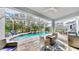 Spacious pool area with covered patio, fire pit, and grill at 1457 Olympic Club Blvd, Champions Gate, FL 33896