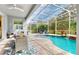 Inviting pool area with covered patio, fire pit, and lounge chairs at 1457 Olympic Club Blvd, Champions Gate, FL 33896