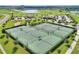Six well-maintained tennis courts surrounded by lush landscaping at 1457 Olympic Club Blvd, Champions Gate, FL 33896