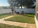 Charming backyard with fire pit and stone pathway at 124 Dakota Ave, Groveland, FL 34736