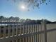 Lake view from backyard, featuring a white picket fence at 124 Dakota Ave, Groveland, FL 34736