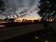Evening view of backyard and lake at 124 Dakota Ave, Groveland, FL 34736