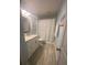 Clean bathroom, featuring a shower/tub combo, vanity, and tile flooring at 124 Dakota Ave, Groveland, FL 34736
