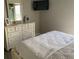 Bedroom with dresser, mirror and a queen-size bed at 124 Dakota Ave, Groveland, FL 34736