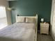 Bright bedroom with a queen-size bed, nightstand, and ample floor space at 124 Dakota Ave, Groveland, FL 34736