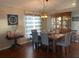 Spacious dining area featuring a farmhouse table and elegant light fixture at 124 Dakota Ave, Groveland, FL 34736