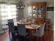 Bright dining room with a wooden table, gray chairs, and a china cabinet at 124 Dakota Ave, Groveland, FL 34736