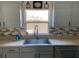 Modern kitchen with stainless steel sink and updated backsplash at 124 Dakota Ave, Groveland, FL 34736