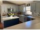 Modern kitchen with blue cabinets, an island, and updated countertops at 124 Dakota Ave, Groveland, FL 34736