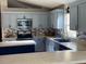 Modern kitchen with stainless steel appliances and light gray cabinets at 124 Dakota Ave, Groveland, FL 34736