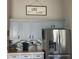 Updated kitchen with stainless steel appliances and gray cabinets at 124 Dakota Ave, Groveland, FL 34736