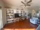 Spacious living room featuring hardwood floors, built-in shelving, and a view into the kitchen at 124 Dakota Ave, Groveland, FL 34736