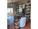 Living room with hardwood floors, built-in shelving, and a comfy seating area at 124 Dakota Ave, Groveland, FL 34736