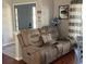 Cozy living room with a brown recliner sofa and a stylish lamp at 124 Dakota Ave, Groveland, FL 34736