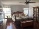 Spacious main bedroom with wood flooring, large bed, and ample storage at 124 Dakota Ave, Groveland, FL 34736
