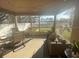 Spacious screened-in porch with seating and lake view at 124 Dakota Ave, Groveland, FL 34736