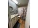 Cozy bathroom features decorative shower curtain, gray walls, and light wood floors at 2488 Hartridge Point W Dr # 2488, Winter Haven, FL 33881