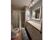 Cozy bathroom with a shower/tub combination and a single sink vanity with a neutral countertop at 2488 Hartridge Point W Dr # 2488, Winter Haven, FL 33881