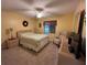 A cozy bedroom with carpet features a ceiling fan, soft lighting, and neutral tones at 2488 Hartridge Point W Dr # 2488, Winter Haven, FL 33881