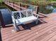 Inviting bench situated on a wooden pier overlooking a tranquil pond, perfect for relaxing and enjoying the peaceful surroundings at 2488 Hartridge Point W Dr # 2488, Winter Haven, FL 33881