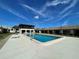 Relaxing community pool area with lounge chairs and a covered patio at 2488 Hartridge Point W Dr # 2488, Winter Haven, FL 33881