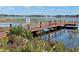 Picturesque dock with a bench overlooking a tranquil lake, providing a serene spot to enjoy nature's beauty at 2488 Hartridge Point W Dr # 2488, Winter Haven, FL 33881