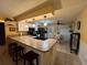 Bright kitchen with island seating, stainless steel appliances, pendant lighting, and breakfast nook with a table at 2488 Hartridge Point W Dr # 2488, Winter Haven, FL 33881