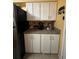 White shaker-style cabinets in the kitchen at 2488 Hartridge Point W Dr # 2488, Winter Haven, FL 33881