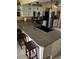 Kitchen with a sink island, stainless steel appliances, pendant lighting, and breakfast nook through a doorway at 2488 Hartridge Point W Dr # 2488, Winter Haven, FL 33881