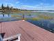 Relaxing lakefront dock with bench, offering serene water views at 2488 Hartridge Point W Dr # 2488, Winter Haven, FL 33881
