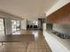 Spacious living room boasts tile flooring, a spiral staircase, and ample natural light from sliding glass doors at 2488 Hartridge Point W Dr # 2488, Winter Haven, FL 33881