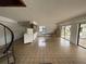 Open-concept living room featuring tile flooring, a spiral staircase, and sliding glass doors to outdoor space at 2488 Hartridge Point W Dr # 2488, Winter Haven, FL 33881