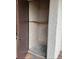 A pantry with an open brown door shows off a wooden shelf and concrete floor at 2488 Hartridge Point W Dr # 2488, Winter Haven, FL 33881