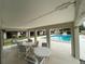 Relaxing community pool area with covered patio and seating at 2488 Hartridge Point W Dr # 2488, Winter Haven, FL 33881