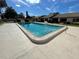 Community swimming pool surrounded by lush greenery, offering a refreshing escape for residents at 2488 Hartridge Point W Dr # 2488, Winter Haven, FL 33881