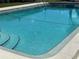 Inviting swimming pool with clear blue water and steps for easy access, perfect for relaxation and recreation at 2488 Hartridge Point W Dr # 2488, Winter Haven, FL 33881