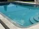 Clear swimming pool with entry steps and a safety rope, inviting residents to enjoy a refreshing swim at 2488 Hartridge Point W Dr # 2488, Winter Haven, FL 33881
