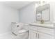 Modern bathroom with white cabinets, quartz countertops, and a toilet at 612 Marina Point Dr # 6120, Daytona Beach, FL 32114