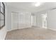 Bright bedroom with gray carpeting and white closet doors at 612 Marina Point Dr # 6120, Daytona Beach, FL 32114