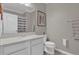 Bathroom with white vanity, toilet, and decorative print at 688 Orange Belt Loop, Winter Garden, FL 34787