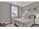 Bedroom with window, soft pink bedding, and wall art at 688 Orange Belt Loop, Winter Garden, FL 34787