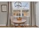 Small dining area with wood table and neutral colored chairs at 688 Orange Belt Loop, Winter Garden, FL 34787