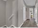 Upper hallway with light grey walls and wood-look flooring at 688 Orange Belt Loop, Winter Garden, FL 34787