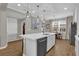 Modern kitchen island with white quartz countertop and stainless steel appliances at 688 Orange Belt Loop, Winter Garden, FL 34787