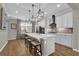 Modern kitchen with white cabinets, a large island, and stainless steel appliances at 688 Orange Belt Loop, Winter Garden, FL 34787