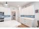 White kitchen with ample counter space and blue tile backsplash at 7865 Sw 89Th Cir, Ocala, FL 34481