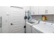 Bright laundry room with washer, dryer, and storage for cleaning supplies at 7865 Sw 89Th Cir, Ocala, FL 34481