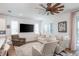 Living room with light-colored furniture and large TV at 7865 Sw 89Th Cir, Ocala, FL 34481