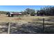 Rustic barn with a metal roof and corral in a large pasture at 2725 Schreffler Rd, Groveland, FL 34736